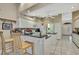 Updated kitchen with white cabinets, granite countertops, breakfast bar and an open view of the entryway at 9730 Reynosa Dr, New Port Richey, FL 34655