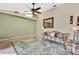 Comfortable living room featuring a decorative rug, couch, and fan at 9730 Reynosa Dr, New Port Richey, FL 34655