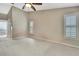 Bright main bedroom with shuttered windows and neutral carpet flooring leading to the ensuite bathroom at 9730 Reynosa Dr, New Port Richey, FL 34655