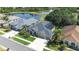 Aerial view of a well-manicured home next to a pond with solar panels on the roof at 10016 Oxford Chapel Dr, Tampa, FL 33647