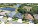 An aerial view of the home's location near a scenic pond, mature trees, and well-kept lawns at 10016 Oxford Chapel Dr, Tampa, FL 33647
