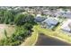 Aerial view of backyards, screened in patios, pool, and pond at 10016 Oxford Chapel Dr, Tampa, FL 33647