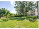 Large, green backyard offering ample space and views, with a fence for added privacy at 10016 Oxford Chapel Dr, Tampa, FL 33647