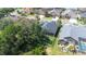 Aerial view of backyard, screen enclosed patio, and dark fence and mature trees at 10016 Oxford Chapel Dr, Tampa, FL 33647