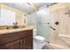 Bathroom with granite countertop, modern fixtures, and a tiled walk-in shower with sliding glass doors at 10016 Oxford Chapel Dr, Tampa, FL 33647
