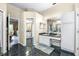 Bathroom with a vanity area, tile flooring, and sliding door to the outdoor patio space at 10016 Oxford Chapel Dr, Tampa, FL 33647