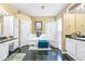 Bright bathroom with dual sinks, a soaking tub, a glass block shower, and stylish tile flooring at 10016 Oxford Chapel Dr, Tampa, FL 33647