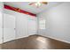 Bedroom featuring hardwood flooring, a window, and closet space perfect for storage at 10016 Oxford Chapel Dr, Tampa, FL 33647