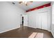 A clean and spacious bedroom with wood floors, white walls, and plenty of closet space at 10016 Oxford Chapel Dr, Tampa, FL 33647