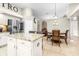Kitchen with granite countertops, stainless steel appliances, an island, and adjacent dining area at 10016 Oxford Chapel Dr, Tampa, FL 33647