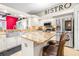 Kitchen featuring stainless steel appliances, granite countertops, a kitchen island, and bar stool at 10016 Oxford Chapel Dr, Tampa, FL 33647