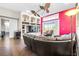 Comfortable living room featuring a large leather sectional sofa, built in shelving, and natural light at 10016 Oxford Chapel Dr, Tampa, FL 33647