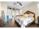 Spacious main bedroom with wood floors, ceiling fan, and en suite bathroom at 10016 Oxford Chapel Dr, Tampa, FL 33647