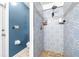 Beautifully tiled shower with rainfall showerhead and convenient built-in shelving at 10016 Oxford Chapel Dr, Tampa, FL 33647