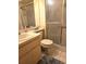Neutral bathroom with a tiled floor, vanity, and shower at 10918 Freemont Dr, New Port Richey, FL 34654