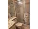 Cozy bathroom featuring a glass shower door, a functional toilet, and a pristine white sink at 10918 Freemont Dr, New Port Richey, FL 34654