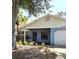 Inviting single-story home featuring a covered entry, attached garage, and manicured lawn at 10918 Freemont Dr, New Port Richey, FL 34654