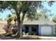 Charming single-story home with a well-maintained yard and mature landscaping at 10918 Freemont Dr, New Port Richey, FL 34654