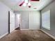 Bedroom features carpet, neutral walls, and a double-door closet and access to other rooms at 11470 Mahopac Rd, Weeki Wachee, FL 34614