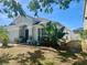 Charming single-story home featuring manicured lawn and mature tropical landscaping at 11529 Misty Isle Ln, Riverview, FL 33579