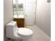 Bathroom with decorative mirror, wooden vanity, tile flooring, and modern toilet at 11622 Declaration Dr, Tampa, FL 33635