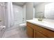 Bright bathroom with tile floors, shower-tub combo, and vanity with white countertop and gold fixtures at 11622 Declaration Dr, Tampa, FL 33635