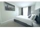 Bedroom with picture of city, neutral walls, carpet, and natural light from a window at 11622 Declaration Dr, Tampa, FL 33635