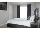 Bedroom with city art, gray curtains, upholstered headboard, and modern nightstand at 11622 Declaration Dr, Tampa, FL 33635
