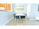 Dining area featuring modern table with velvet chairs, wood-look floors, kitchen view and stylish mirror at 11622 Declaration Dr, Tampa, FL 33635