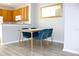 Dining area featuring a modern table with velvet chairs, wood-look floors, and kitchen views at 11622 Declaration Dr, Tampa, FL 33635