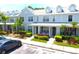 Townhome exterior with lush landscaping, a sidewalk, and a covered entryway under a bright blue sky at 11622 Declaration Dr, Tampa, FL 33635