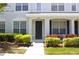 Inviting townhome entrance with manicured landscaping and a charming, covered front door at 11622 Declaration Dr, Tampa, FL 33635