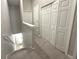 Upstairs hallway with neutral carpet and trim and multiple doors at 11622 Declaration Dr, Tampa, FL 33635