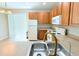 Functional kitchen equipped with wood cabinets, white appliances, and a double stainless steel sink at 11622 Declaration Dr, Tampa, FL 33635