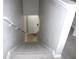 Carpeted stairwell leading to a door and light-colored vinyl flooring at 11622 Declaration Dr, Tampa, FL 33635