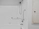White subway tile surround in tub/shower with chrome grab bar and rainfall showerhead fixture at 1225 58Th N St # 204A, St Petersburg, FL 33710