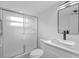 Bathroom featuring frameless glass shower door, vessel sink, and modern fixtures at 1225 58Th N St # 204A, St Petersburg, FL 33710