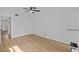 Bright bedroom features wood-look flooring, a ceiling fan, and a fresh, neutral color palette at 1225 58Th N St # 204A, St Petersburg, FL 33710