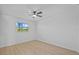 Bedroom with wood-look floors, modern ceiling fan, and window overlooking backyard at 1225 58Th N St # 204A, St Petersburg, FL 33710