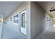 Exterior of a condominium with a white door, multiple windows, and a covered walkway at 1225 58Th N St # 204A, St Petersburg, FL 33710