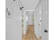 Bright hallway with wood floors, white walls and trim with two doors visible at 1225 58Th N St # 204A, St Petersburg, FL 33710