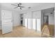 Sunlit room featuring laundry appliances and mirrored closet doors with wood-look floors at 1225 58Th N St # 204A, St Petersburg, FL 33710
