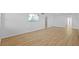 A spacious living room with wood flooring, white walls, and a mounted television at 1225 58Th N St # 204A, St Petersburg, FL 33710