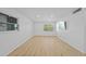 Bright living room with wood floors, white walls and trim, recessed lights and large TV at 1225 58Th N St # 204A, St Petersburg, FL 33710