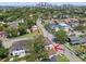 Aerial view of a home in a neighborhood with mature trees; cityscape in the distance at 134 Chesapeake Ave, Tampa, FL 33606