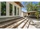 Backyard featuring outdoor seating, landscaping, and stone steps leading to french doors at 134 Chesapeake Ave, Tampa, FL 33606