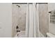 Bathroom showing a shower-tub combo, a white curtain, and a neutral-colored tile scheme at 134 Chesapeake Ave, Tampa, FL 33606