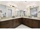 Spacious bathroom featuring double vanity with granite countertop and dark wood cabinets at 134 Chesapeake Ave, Tampa, FL 33606