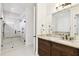 Bright bathroom featuring a glass-enclosed shower, and a granite-topped vanity with double sinks at 134 Chesapeake Ave, Tampa, FL 33606