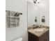 Half bathroom showcasing a granite vanity with decorative accents and a towel rack at 134 Chesapeake Ave, Tampa, FL 33606